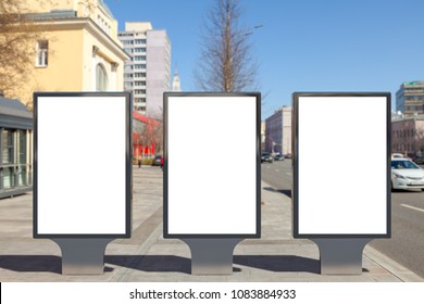 Three Blank Street Billboard Poster Stands On City Background. 3d Illustration.