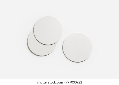 Three blank white beer coasters on paper background. Responsive design mockup. Flat lay.