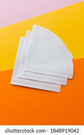 Three bleached paper coffee filters isolated. Alternative brewing pour over coffee. Minimalistic abstract background pink yellow orange colour - Shutterstock ID 1848919042