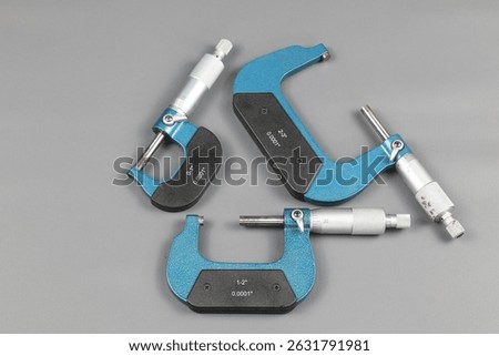 Three blue micrometers with various sizes, a micrometer is a tool to precisely measure the outer diameter and length (thickness) of an object to be measured by clamping it.