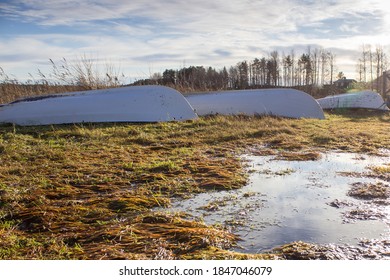 Three boats lying upside down on the shore