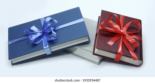 Three books with bows on a white background