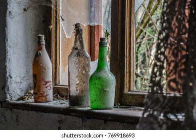 three bottles with broken window in a house
