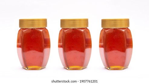 Three bottles of fresh natural honey jars filled.