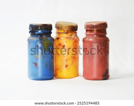 three bottles of screen printing paint in blue, yellow and red with a white screen background