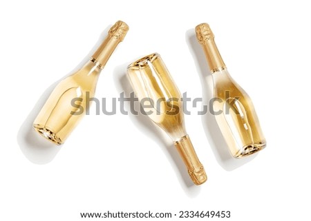Three bottles of white sparkling wine, set full glass champagne bottles close up, isolated on white background, cutout design object, sunlight, shadow. Summer alcoholic drinks rose wine, top view