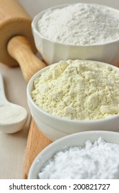 Three Bowls With Gluten Free Flour - Rice Flour, Millet Flour And Potato Starch And Spoon With Xanthan Gum