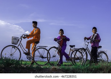 Three Boy With Bicycles At Paddy Field At Parit Penghulu, Sungai Rambai, Melaka During Blue Sky