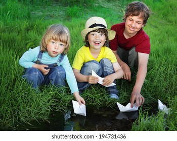 three boy play in  stream
