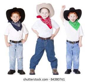 Three boys dressed up as cowboys in studio