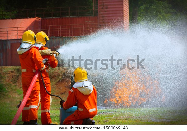 Three Brave Firefighter Using Extinguisher Water Stock Photo 1500069143 ...