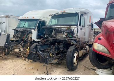 Three broken trucks in junk yard after accident, discarded salvage cars with crashed engines. Outdoor park with automobile wreckage parts debris - Shutterstock ID 2157610227