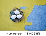 three brown eggs in yellow background