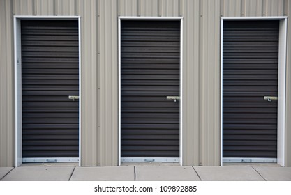 Three Brown Metal Doors Of An Outdoor Storage Unit