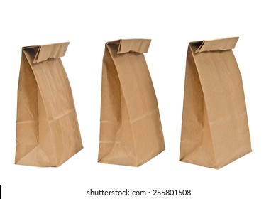 Three Brown Paper Lunch Bags With Tops Folded Isolated On White Background