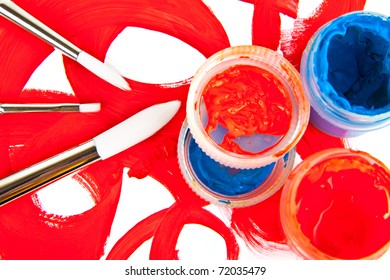 three brushes and tubes with paint