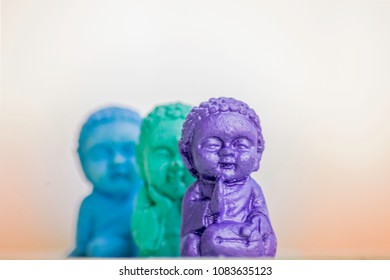 Three Buddhas in different positions where one is main in the shot and the rest are out of focus
