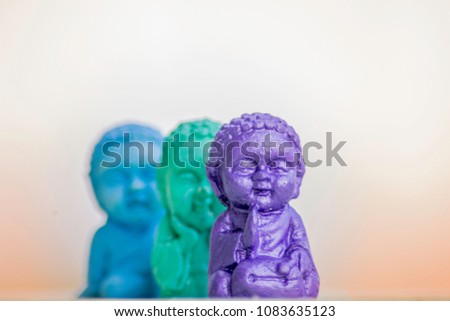 Three Buddhas in different positions where one is main in the shot and the rest are out of focus
