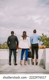 Three Business Colleagues Standing On The Top Of The Building