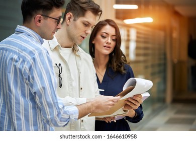 three business people analyzing the report, journalist looking at the srticle, searching necessary information, team work, paper work