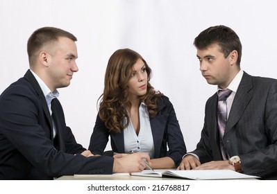 Three Business People Discuss The Deal.