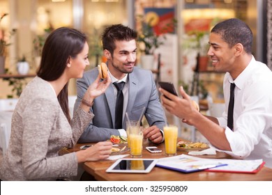 Three Business people Having Meeting In Outdoor Restaurant