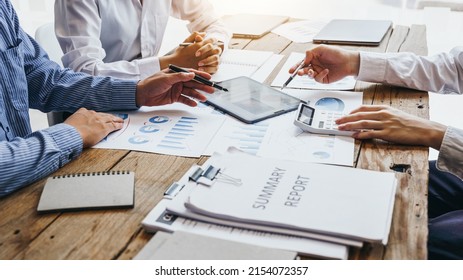 Three Business People Meeting At Wooden Desk, Analysis And Calculate Accounting Finance Data, Stats.