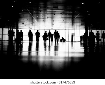 Three Business People Walking Down The Street Talking. Silhouettes.