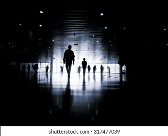 Three Business People Walking Down The Street Talking. Silhouettes.