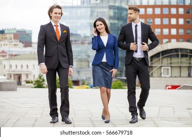 Three Business People Walking Outside Office