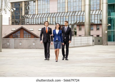 Three Business People Walking Outside Office