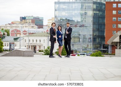 Three Business People Walking Outside Office