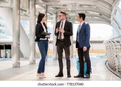 Three Business People Walking Outside Office