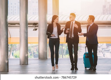 Three Business People Walking Outside Office