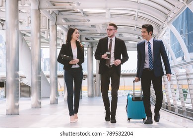 Three Business People Walking Outside Office