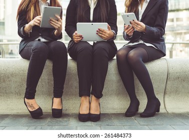 Three Business Women Working On Their Pad During The Lunch Break