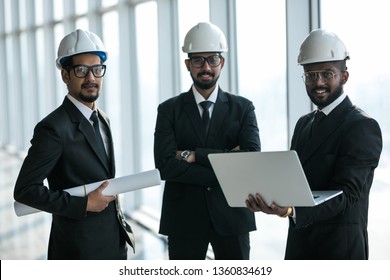 Three Businessmen In Ties And Hardhats Surprised With Window Scene. Property Investor Visiting Site And Impressed With Neighboring Construction.