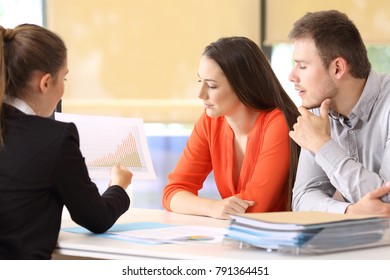 Three businesspeople analyzing a growth graph at office