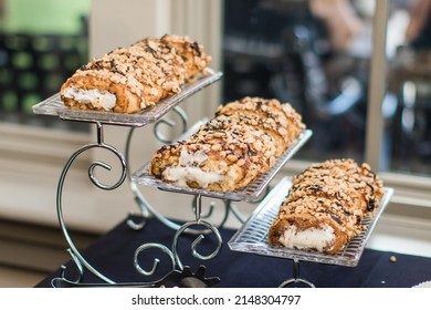 Three Cake Rolls On A Silver Metal Cake Stand 