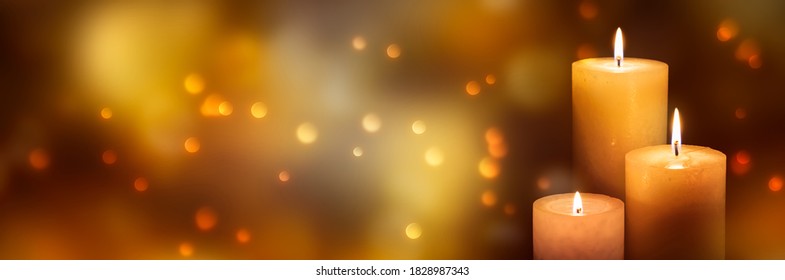 three candle lights at the edge of blurred festive background, decorative golden shiny candle lights - Powered by Shutterstock