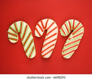 Three Candy Cane Sugar Cookies With Decorative Icing.