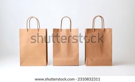 Three cardboard recycled shopping bags. Brown kraft paper mockup packaging eco retail carry bag close up focus photo