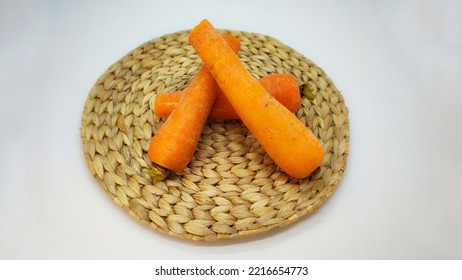 Three Carrots On A Rattan Plate