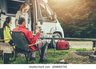 Three Caucasian Friends In Their 40s On RV Road Trip. Overnight Dry Camping Stay  In A Wilderness. Recreational Vehicle Theme.