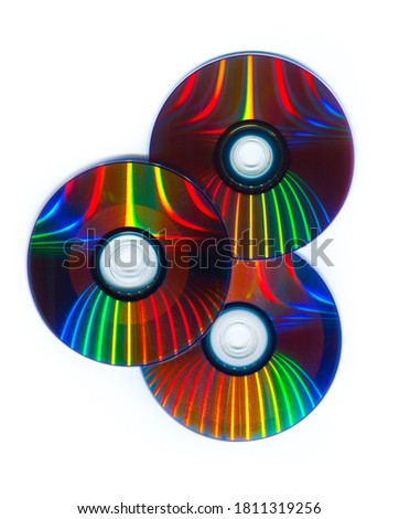 
Three CDs / DVDs on a white background, Computer information storage technology.