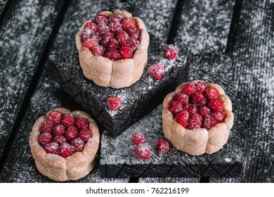 Three charlotte cakes with raspberry on wood background - Shutterstock ID 762216199