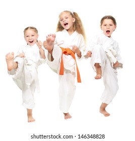Three cheerful girl dressed in a white kimono kick leg