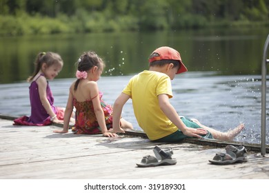 Three Cheerful Kids Playing On The Lake