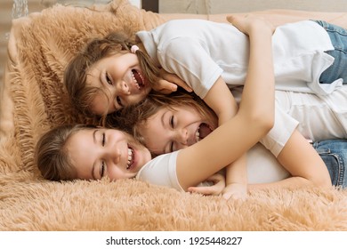 Three Cheerful Sisters, Children In Their Arms. Children's Games And Laughter