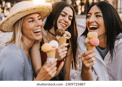 Three cheerful teenage women eating ice cream cones on city street - Happy female tourists enjoying summer vacation in Italy - Summertime holidays - Powered by Shutterstock